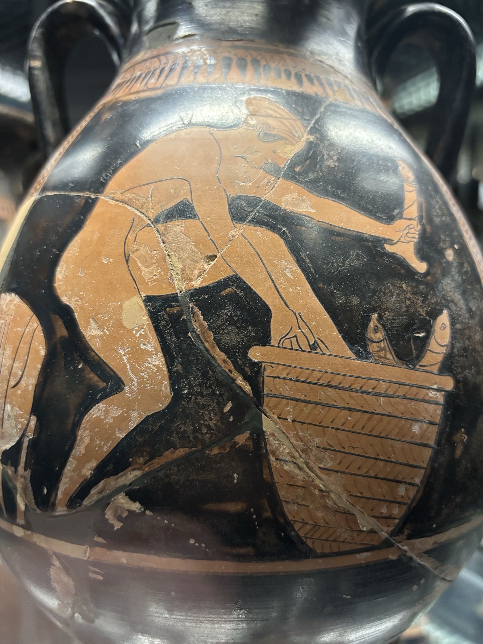 Woman climbing into a basket of penises - Siracusa